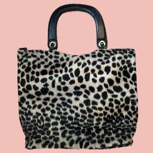 Soft short faux fur tote in a bold leopard print with structured black handles